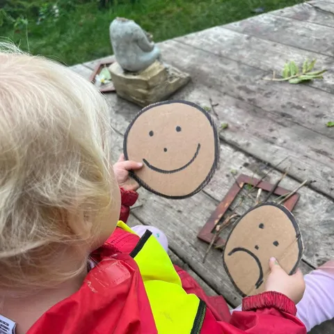 Children building dens and shelters during Forest School