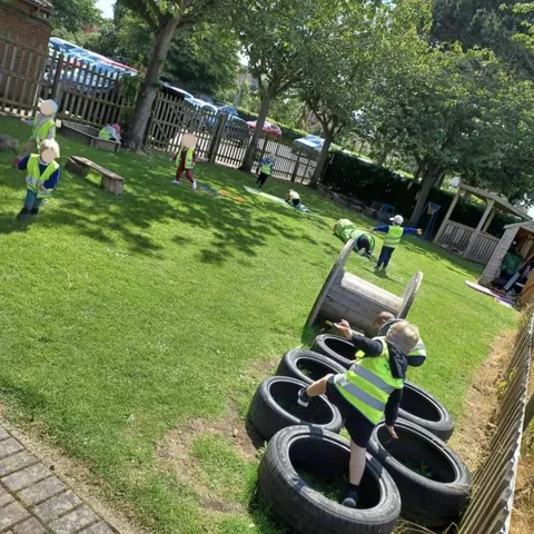 Children developing physical skills on the outdoor obstacle course