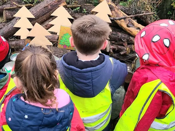 Children exploring together during a Forest School session at Early Years Educare