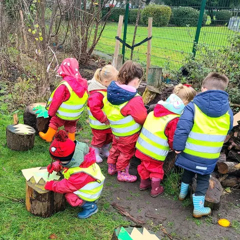 Story time under the trees at Forest School