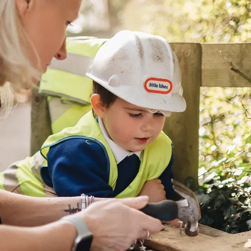 Child exploring and building at Early Years Educare