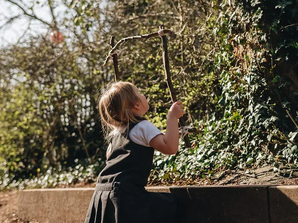 Children exploring nature during a Forest School session at Early Years Educare