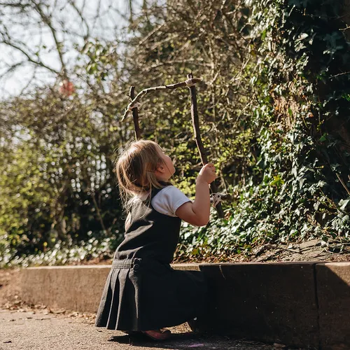 Children exploring nature during a Forest School session