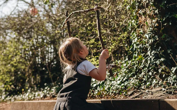 Children exploring nature during a Forest School session