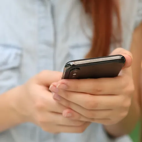 Parent using the Famly app on their phone